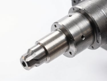 Crisp high-key macro photograph of a clean CNC mill spindle cutting billet aluminum, bright white daylight, metallic reflections, 50mm