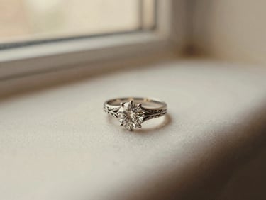 Close-up of a vintage engagement ring with a central diamond and intricate filigree, resting on a silk cloth, soft light.