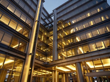 Modern corporate lobby with high ceilings, glass panels, and elegant architectural lighting, twilight perspective.
