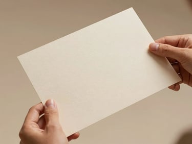 Close-up of elegant hands holding a minimalist textured certificate paper, soft studio lighting, warm sand tones, shallow depth of field