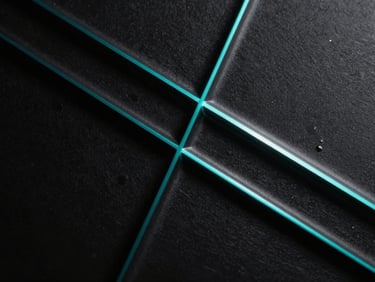 Abstract dark glass texture with sharp geometric lines and electric cyan light refraction, macro studio shot