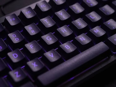 Extreme close-up of a premium mechanical keyboard with subtle purple backlighting, dark obsidian keycaps, low-key lighting