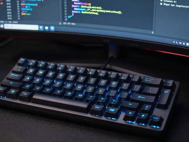 Macro shot of a mechanical keyboard and a clean IDE codebase on a curved monitor, sharp electric blue key lights reflecting on the keys, dark high-contrast studio setting.