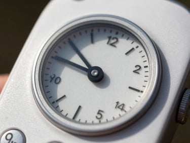 Macro view of a circular volume dial on a white mobile interface, bright sunlight highlighting tactile ridges