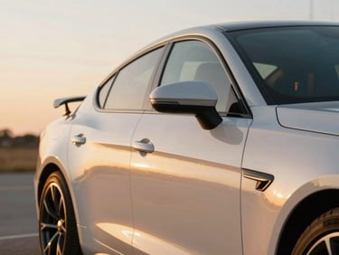 A close-up profile of a pristine, modern sports sedan parked in soft golden hour Texas light, clean metallic paint reflecting the warm horizon, background uncluttered.