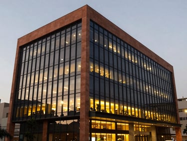 Angular view of a modern corporate building in San Isidro, Lima, at dusk, warm interior lights reflecting on glass facade, professional architectural photography