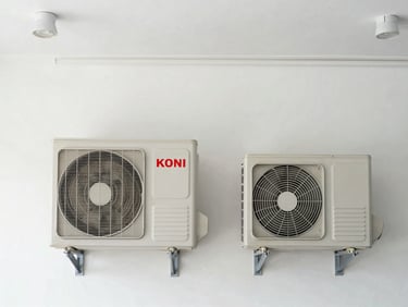 A straight-on medium shot of a pristine indoor wall air-conditioning unit and its outdoor compressor, clean utility lighting, no people.
