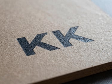 Macro shot of a UV-printed textured surface on rigid board, ink sitting on raised grain, sharp colour detail under diffused studio light, material edge visible at bottom