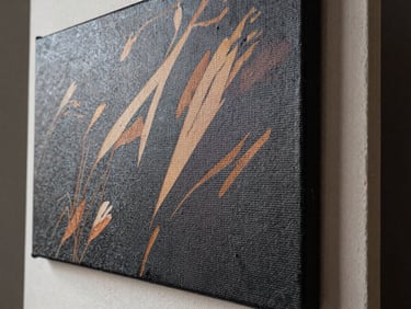 Close-up of a textured canvas print mounted on a rigid board, surface weave visible beneath the printed image, studio daylight from left, sharp detail