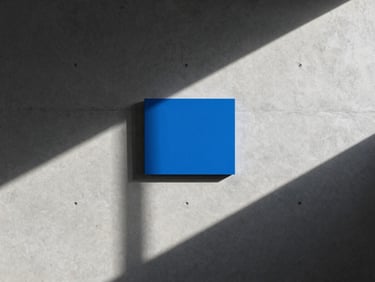Abstract geometric shadows casting on a clean concrete office wall, minimalist architectural crop, cool daylight.