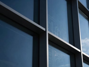 Macro close-up of high-end architectural glass and steel in Padova, cool navy tones, sharp white highlights, 35mm lens