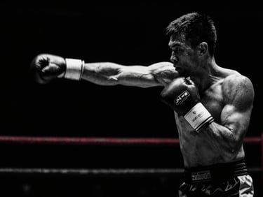 Dynamic motion blur of a fighter throwing a straight left jab, high-contrast black and white, dramatic side-lighting