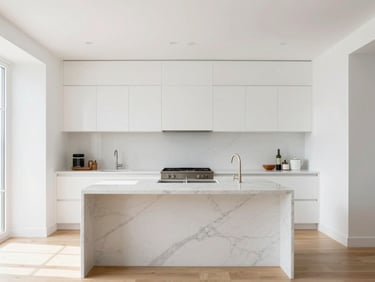 Straight-on architectural shot of a bright modern kitchen, clean white walls, marble island with elegant grey veins, natural high-key daylight, 35mm.