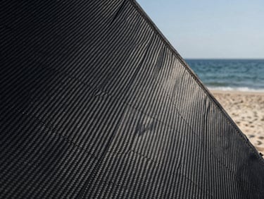 Detailed texture of black carbon fiber sail cloth, geometric grid, high-contrast minimalist composition