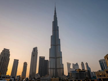 Cinematic wide shot of the Dubai skyline at twilight, featuring the Burj Khalifa piercing the soft golden and blue sky.