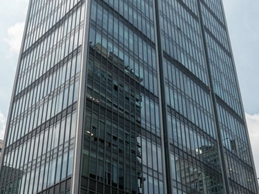 Architectural detail of a modern business hub in Mexico City, clean lines, glass reflections, natural daylight.