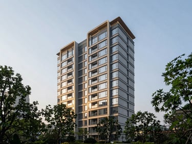 Wide-angle architectural photography of a modern concrete and glass luxury residential tower at sunrise, soft morning sunlight reflecting off clean glass facades, deep forest green foliage framing the lower third, high-contrast editorial look, 35mm.