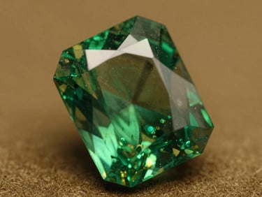 Extreme macro photograph of a Colombian emerald facet, showcasing the warm green chromium glow and delicate natural jardin under directional light