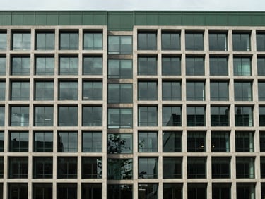 Modern architectural concrete and glass facade in Rotterdam, structured grid pattern, overcast European daylight