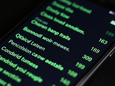 Close-up of a high-end Android phone screen showing a terminal-style system log, sharp green text on a deep black background.