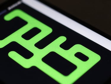 Extreme close-up of a high-end Android screen displaying a clean minimalist puzzle game interface, sharp neon green glowing paths, dark low-key studio lighting, 50mm