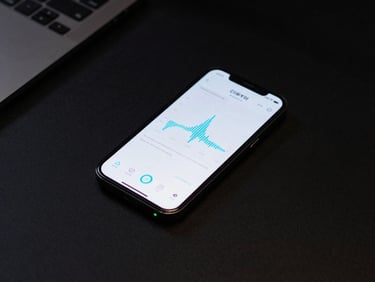 Overhead view of a minimalist black desk with a single phone displaying a clean wireframe metric chart, neon cyan accents.