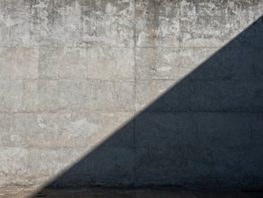 Wide panoramic shot of a brutalist concrete wall intersected by sharp diagonal sunlight, deep shadows, absolute stillness.