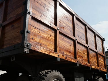Low-angle heroic shot of a traditional Colombian wooden-stake truck body, polished wood, heavy steel joints, high-contrast natural daylight, 35mm