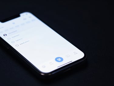 Wide panoramic macro shot of a physical mobile device displaying a clean IDE-inspired mobile app interface, cool low-key studio lighting with subtle blue highlights, generous negative space on the right side.