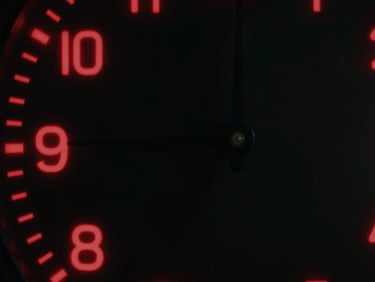 Abstract shot of a stylized clock with digital elements, glowing red accents, representing efficiency and precision, cinematic, high-contrast, deep blacks.