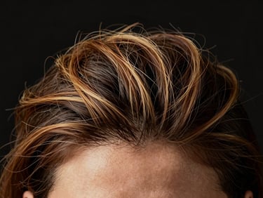 Macro shot of a healthy scalp with strong hair follicles, warm studio lighting, rich black background, shallow depth of field, 85mm lens