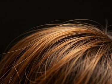 Macro shot of a hair strand under a microscope, showing healthy hair fiber, warm studio lighting, rich black background, shallow depth of field, 85mm lens
