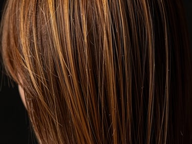 Close-up of healthy hair strands, reflecting light, after a deep treatment, warm studio lighting, rich black background, shallow depth of field, 85mm lens