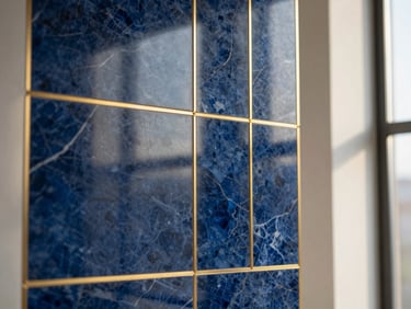 Close-up of premium Italian marble being precisely installed on an interior feature wall, gold metal inlay details, soft natural window light, sharp focus, 35mm lens.