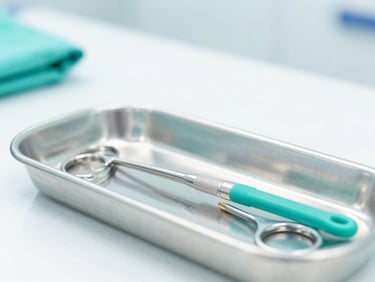 Sharp macro shot of a sterile surgical instrument tray under bright clinical lights, clean white backdrop, fresh aqua accents.