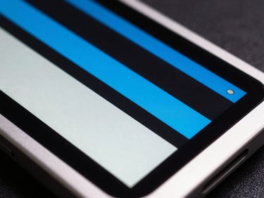 High-contrast macro shot of a sleek aluminum device screen displaying a stark brutalist layout with electric blue accents.