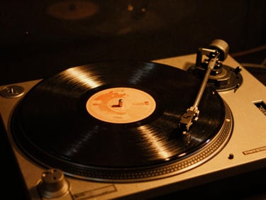 A vintage vinyl record spinning on a turntable under warm amber stage light, high contrast, 35mm film grain