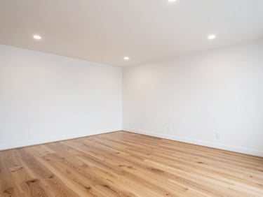 Bright modern finished basement with clean sheetrock walls, recessed lighting, and premium hardwood flooring, crisp focus
