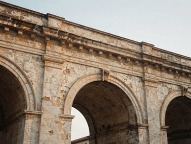 Quiet architectural detail of a weathered Roman archway in Trieste, soft diffused overcast daylight, muted earth tones, 35mm film.