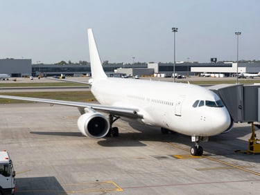 Wide environmental shot of a cargo plane on a tarmac under bright, clinical daylight, organized logistics hub.