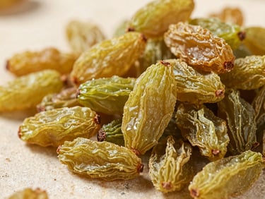 Macro photography of premium long green raisins on a neutral stone background, sharp detail, natural sunlight.