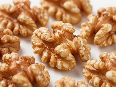 Macro shot of shelled walnuts and pine nuts, crisp studio lighting, focus on rich textures.