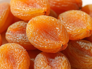 Macro of premium dried golden apricots stacked neatly, warm direct sunlight, rich orange-gold tones
