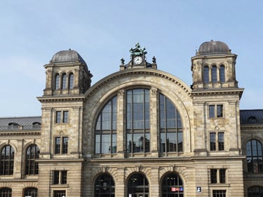 Crisp editorial travel photography of historic Munich rail station architecture, sharp perspectives, bright natural daylight