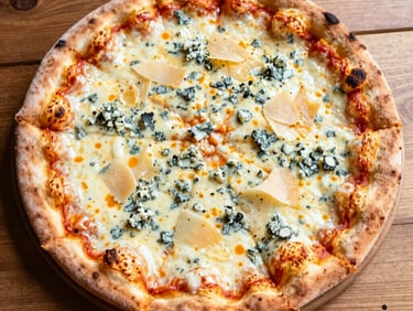 Close-up of a Neapolitan pizza with 'nduja sausage and roasted red peppers, vibrant orange and red tones, intense firelight glow.