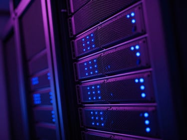 Sleek tech photography of server racks with blinking blue indicator lights, dynamic perspective, low-key dramatic lighting.