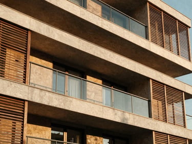 Tight architectural crop of a modern apartment balcony with wooden louvers, warm late-afternoon sun