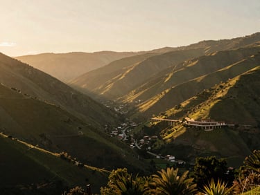 Wide environmental landscape shot of green valleys in Etla, soft golden hour lighting.