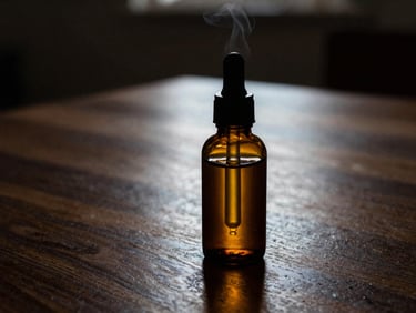 Close-up of an amber glass dropper bottle on a dark walnut counter, warm side-lighting catching the golden liquid, soft steam in the background.