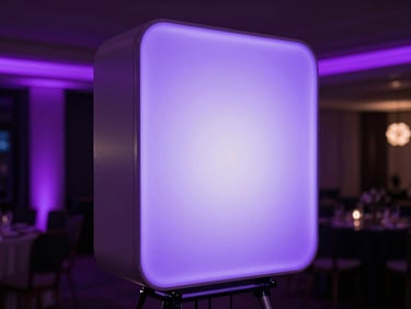 Sleek minimalist photo booth totem glowing with soft purple ambient light, elegant event background, professional studio lighting, 35mm